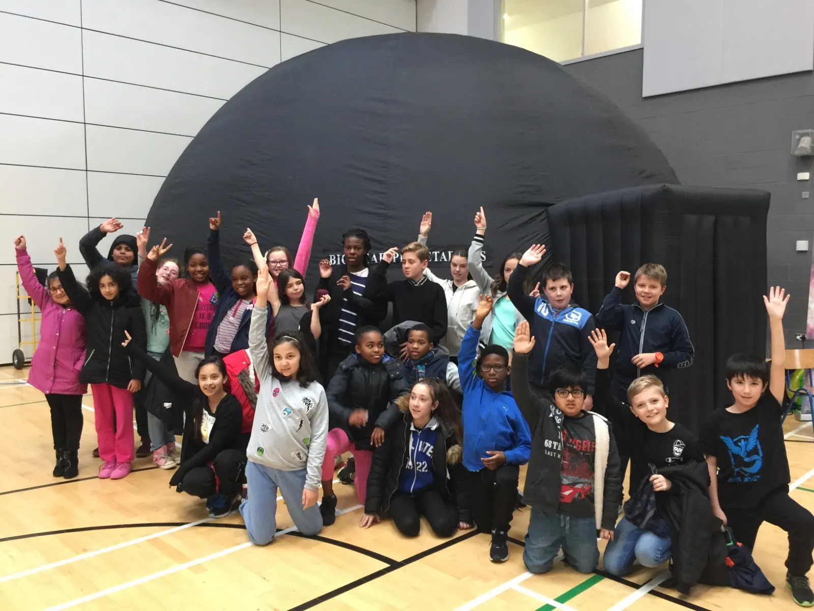 A class cheering in front of the planetarium