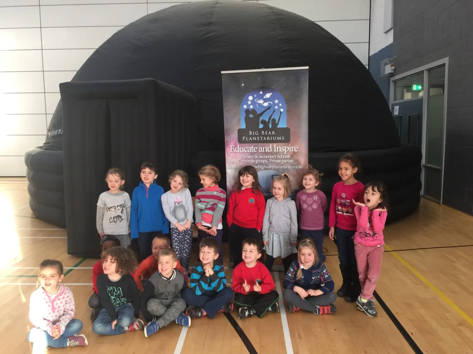 Young children excited in front of the planetarium